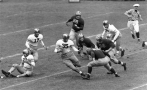 FILE - In this Oct. 13, 1945, file photo, Army halfback Felix Blanchard (35) weaves away as three Michigan men close in to tackle him after a 3-yard first-period gain in a college football game in New York. Michigan players are Stuart Wilkins (68), Dominic Tomasi (65), Harold Watts (58), and Walter Teninga (42). Army's Albert Nemetz (75) is in the background. Felix "Doc" Blanchard, the 1945 Heisman Trophy winner and Army's Mr. Inside in one of college football's most famous backfields, has died. He was 84. (AP Photo/File)